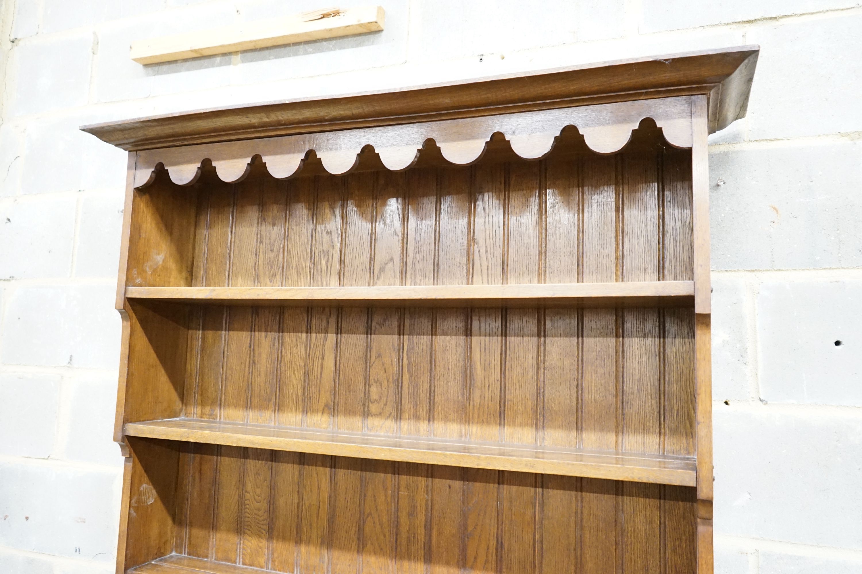 A 1920's oak dresser and plate rack, width 122cm, depth 51cm, height 211cm